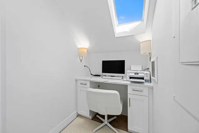 a view of a workspace with furniture