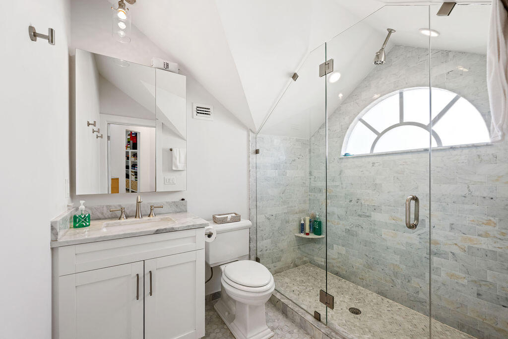 173 Peruvian Avenue, Unit 5 Palm Beach, FL 33480 - Photo 9 of 12 a bathroom with a toilet sink vanity granite and shower