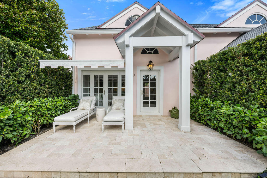 173 Peruvian Avenue, Unit 5 Palm Beach, FL 33480 - Photo 10 of 12 a view of white house with a small yard plants and large tree