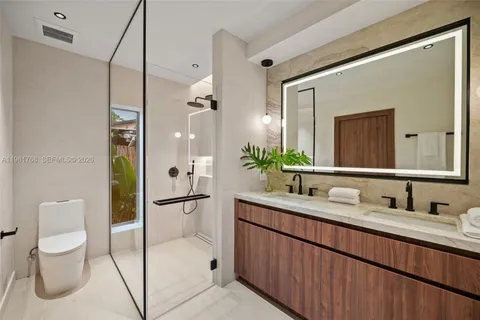 a bathroom with a double vanity sink mirror double and shower