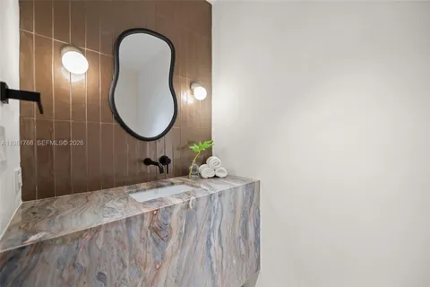 a bedroom with a bed and a mirror