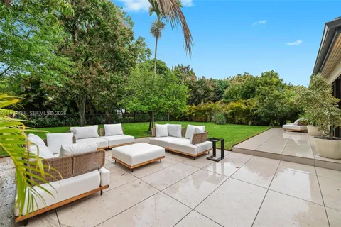 a backyard of a house with outdoor seating