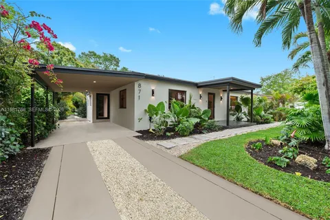 a front view of a house with a garden