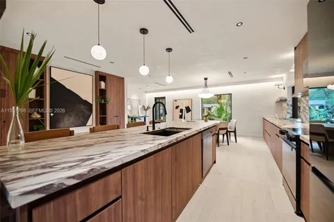 a kitchen with stainless steel appliances kitchen island granite countertop a sink and a stove