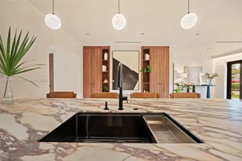a kitchen with stainless steel appliances granite countertop a sink and a refrigerator