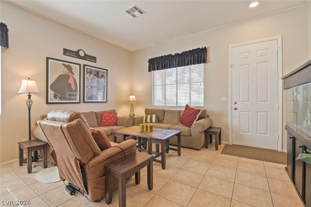 2356 Tilden Way Henderson, NV 89074 - Photo 6 of 30 A welcoming living room featuring warm tile flooring and ample space for relaxation.