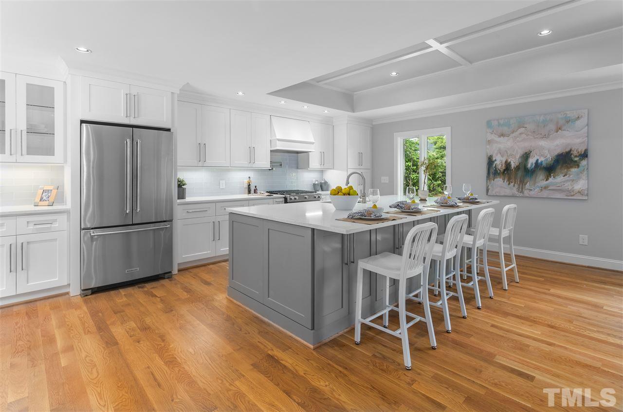 2209 Nancy Ann Drive Raleigh, NC 27607 - Photo 5 of 30 The centerpiece of the primary living area, this kitchen does not disappoint. From the over-sized island, to the top tier appliance, beautiful cabinetry, and crisp white quartz, this kitchen delivers style and usability.