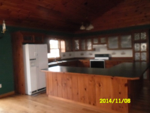 677 Curry Road Churchville, VA 24421 - Photo 4 of 20 a kitchen with stainless steel appliances granite countertop a refrigerator a stove and a sink with wooden floor