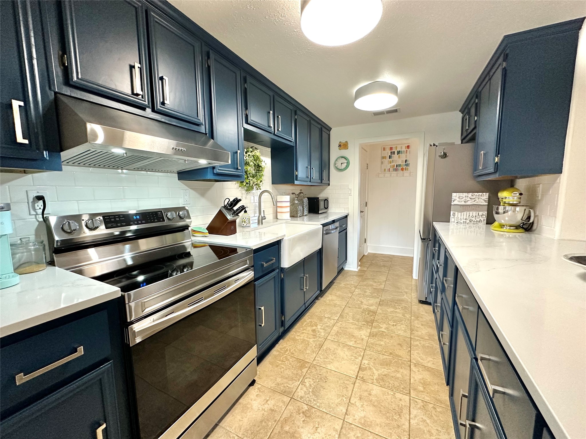 29 Presidio Road Wimberley, TX 78676 - Photo 13 of 36 a kitchen with stainless steel appliances a sink stove and cabinets