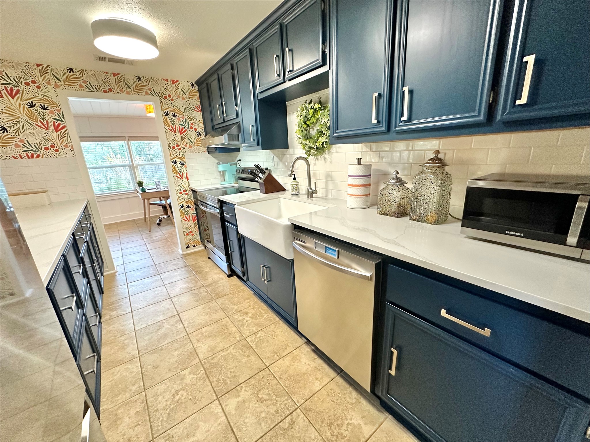 29 Presidio Road Wimberley, TX 78676 - Photo 14 of 36 a kitchen with stainless steel appliances granite countertop a sink stove and cabinets