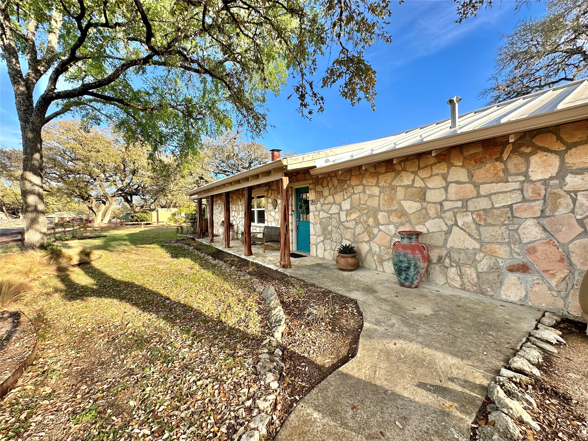 29 Presidio Road Wimberley, TX 78676 - Photo 2 of 36 a view of a house with a patio