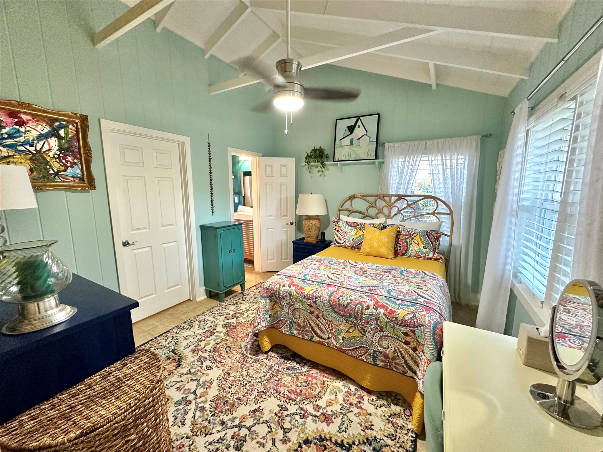 29 Presidio Road Wimberley, TX 78676 - Photo 26 of 36 a bedroom with a bed and a chandelier