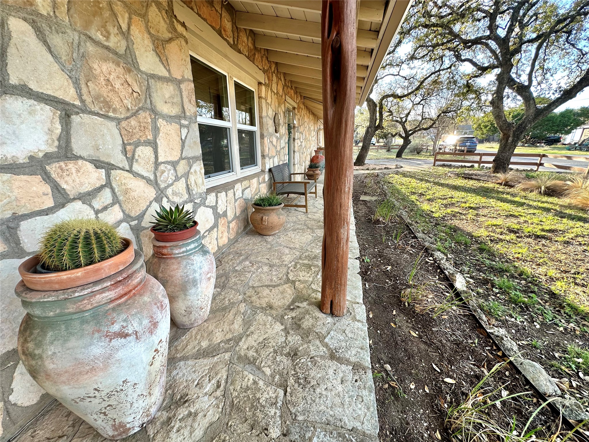 29 Presidio Road Wimberley, TX 78676 - Photo 3 of 36 a view of a backyard with plants and large trees