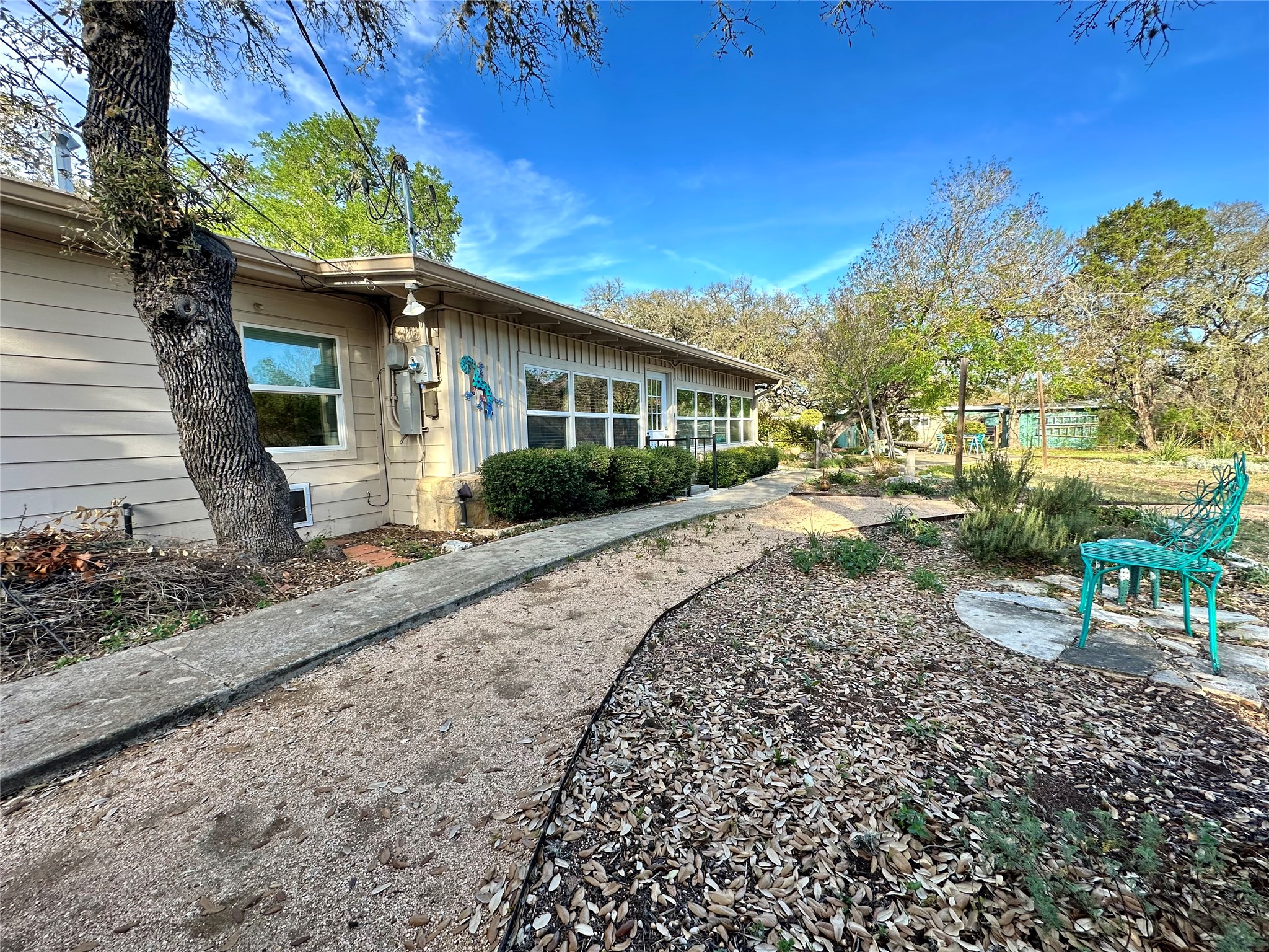 29 Presidio Road Wimberley, TX 78676 - Photo 32 of 36 a front view of a house with garden