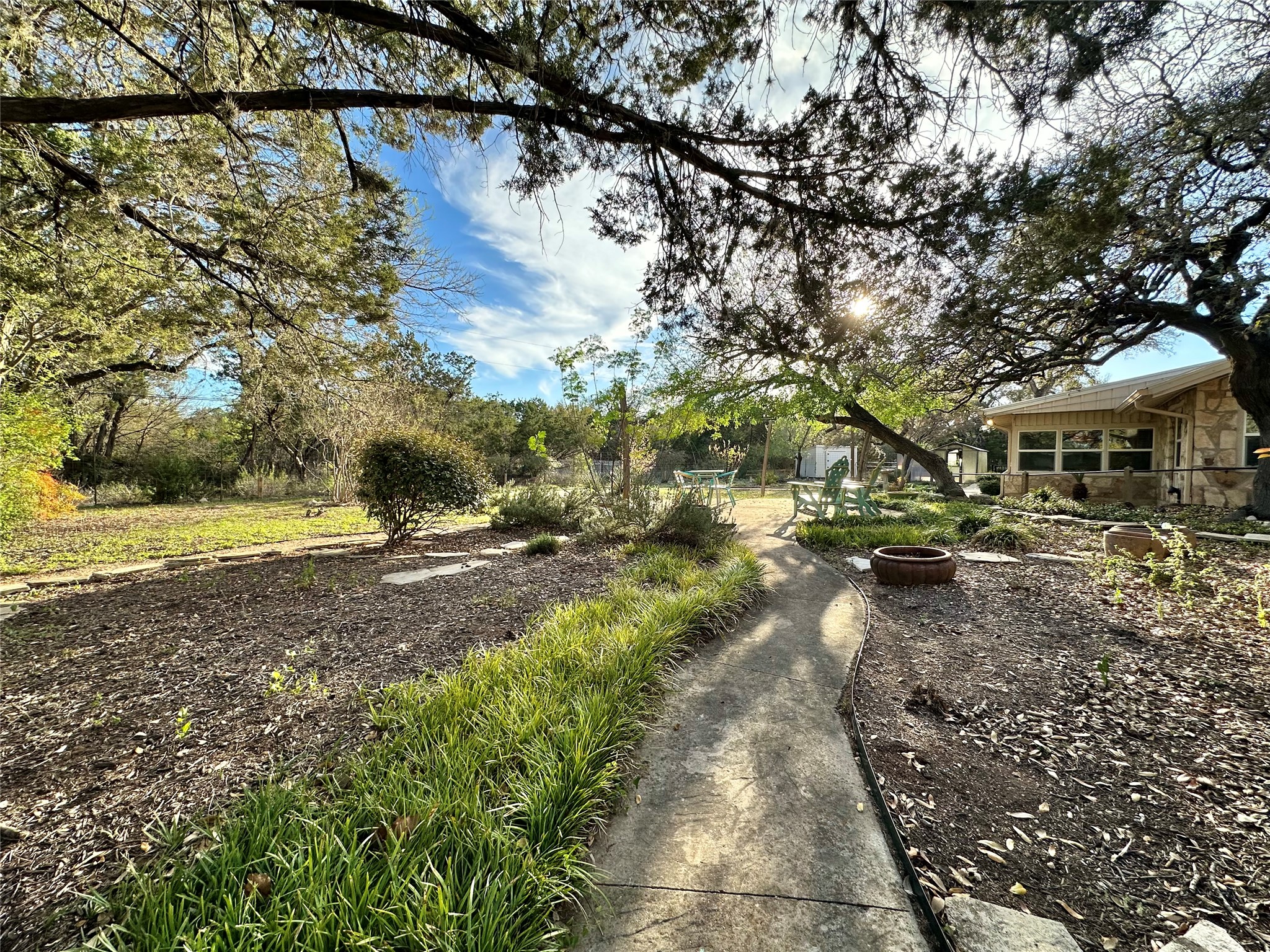 29 Presidio Road Wimberley, TX 78676 - Photo 35 of 36 a view of a yard with plants and large trees