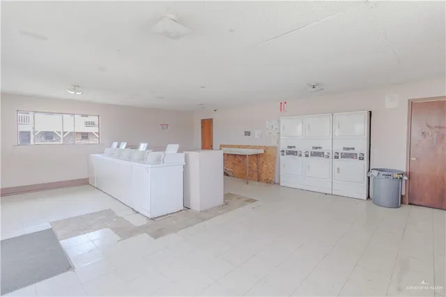 a large white kitchen with a sink