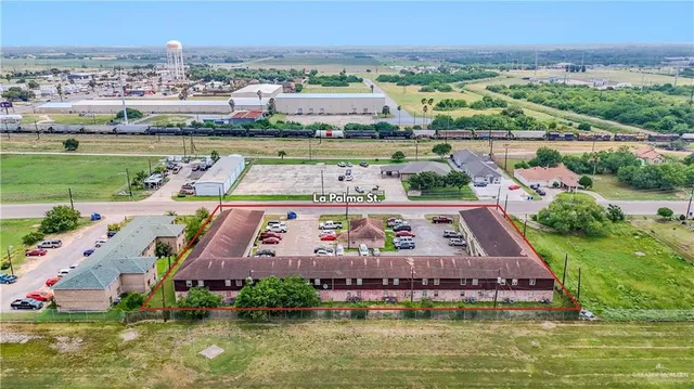 an aerial view of residential houses with outdoor space and lake view