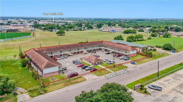an aerial view of a house with a garden and lake view