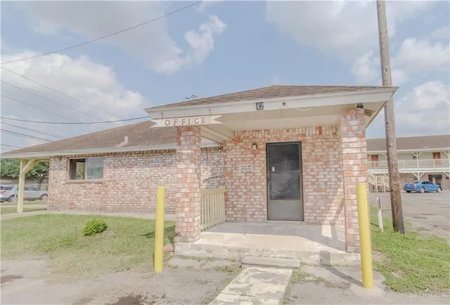 a front view of a house with a garden