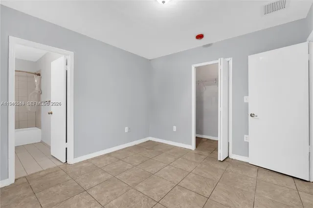 an empty room with window and painted walls