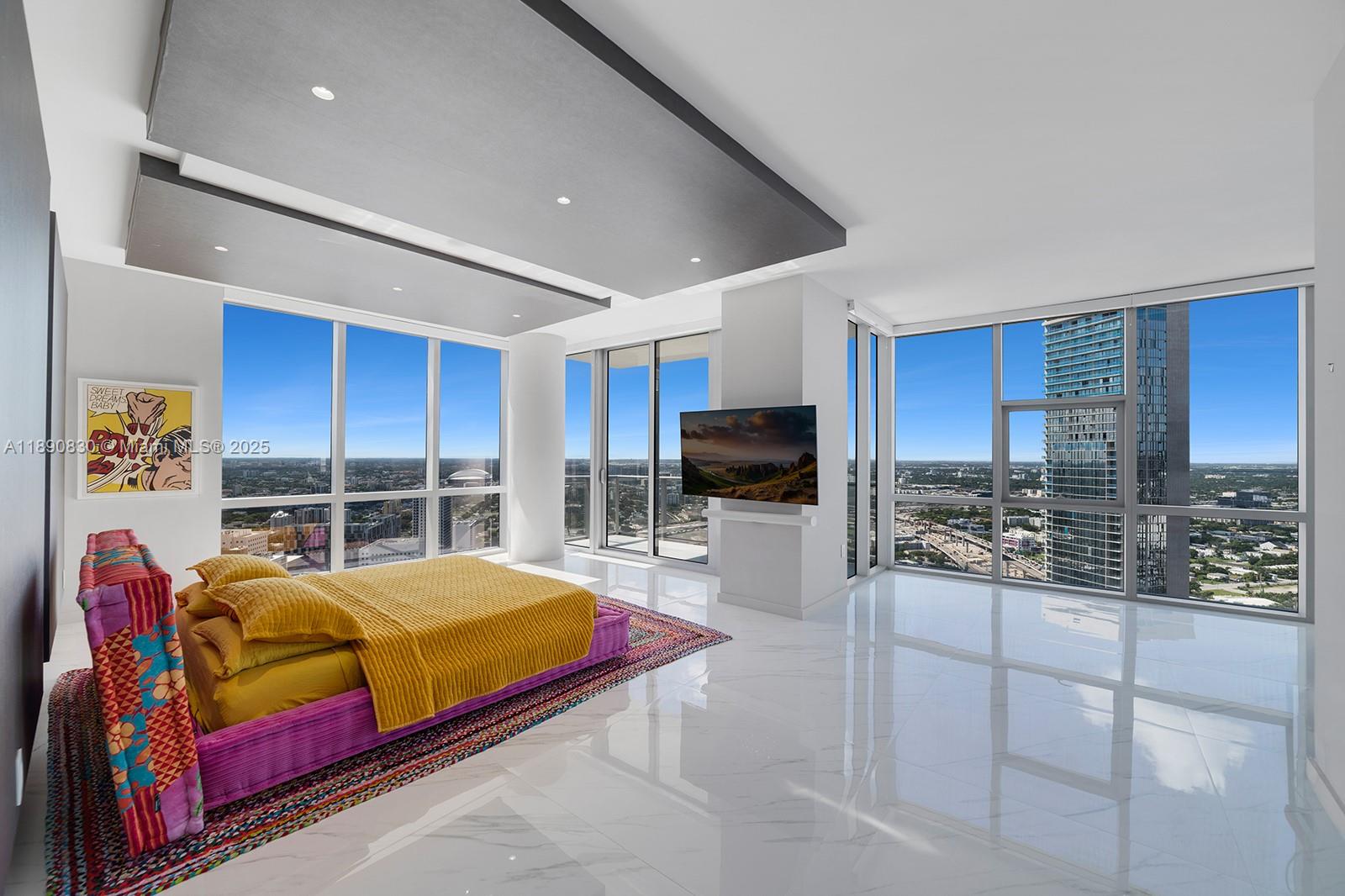 851 Northeast 1st Avenue, Unit 4401/4402 Miami, FL 33132 - Photo 11 of 37 a bedroom with furniture and a flat screen tv