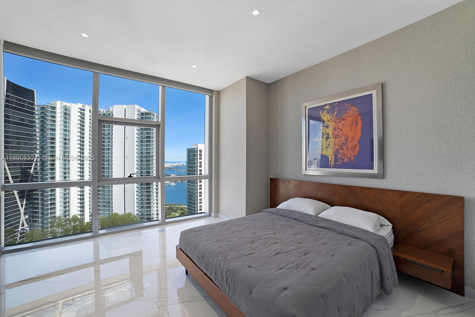 851 Northeast 1st Avenue, Unit 4401/4402 Miami, FL 33132 - Photo 19 of 37 a bedroom with a large bed and a large window