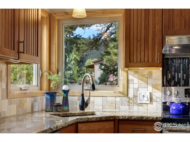 a kitchen with stainless steel appliances granite countertop a sink and cabinets