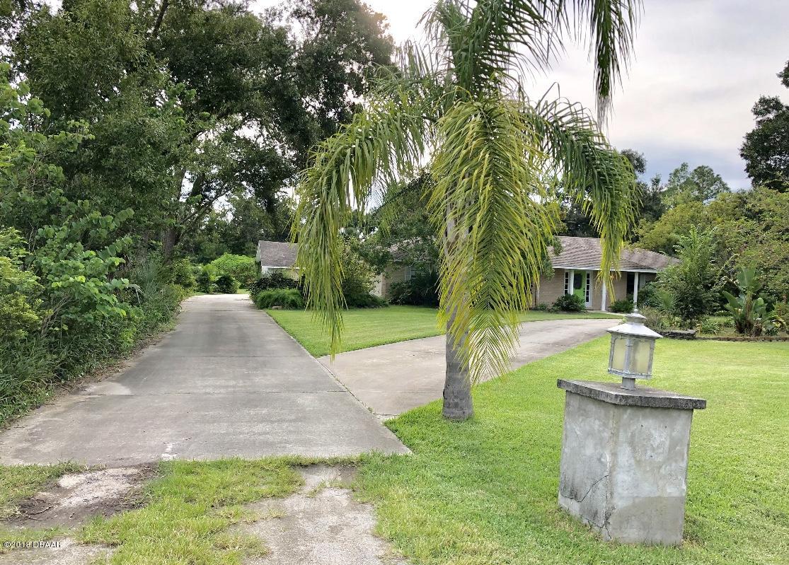 1734 Pinedale Road Edgewater, FL 32132 - Photo 3 of 37 Concrete Driveway Home & Detached Garage