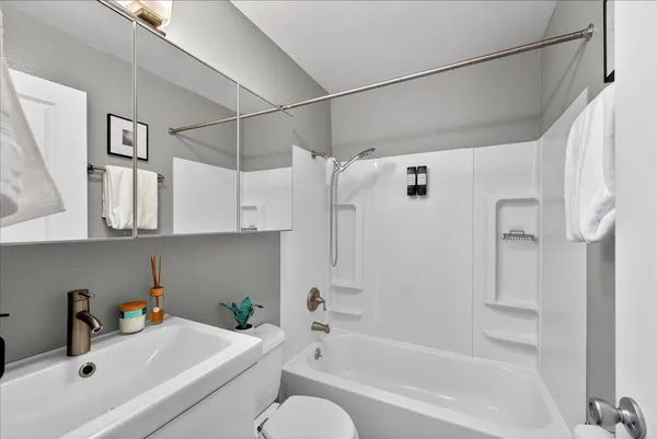 a bathroom with a tub a sink and a shower