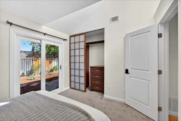 a bedroom with a large bed and a window