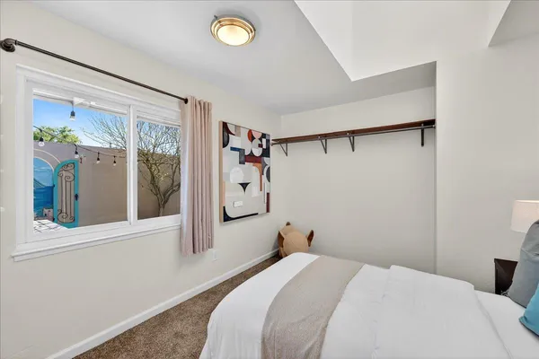 a bedroom with a bed and a window