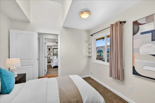 a bedroom with a bed and a window