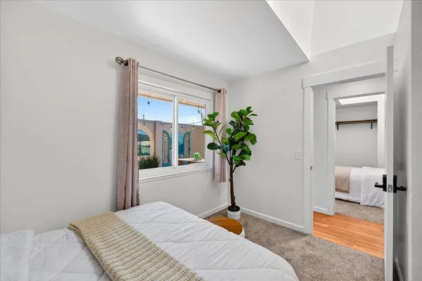 a bedroom with a bed and a window