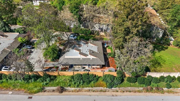 an aerial view of a house with yard