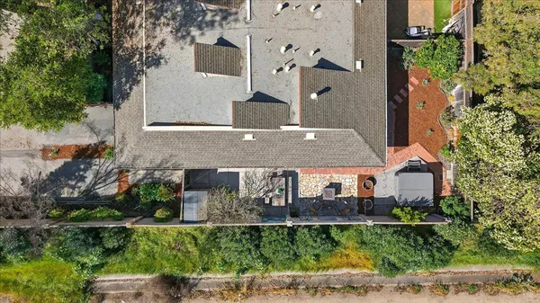 an aerial view of a house with a yard