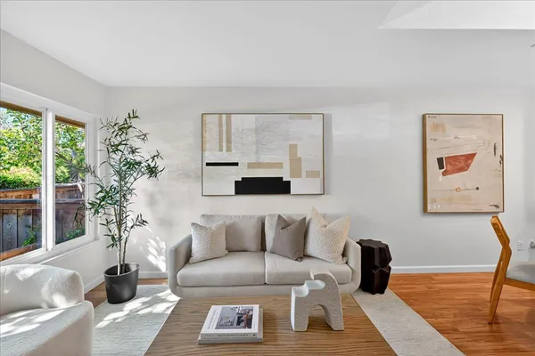 a living room with furniture and a potted plant