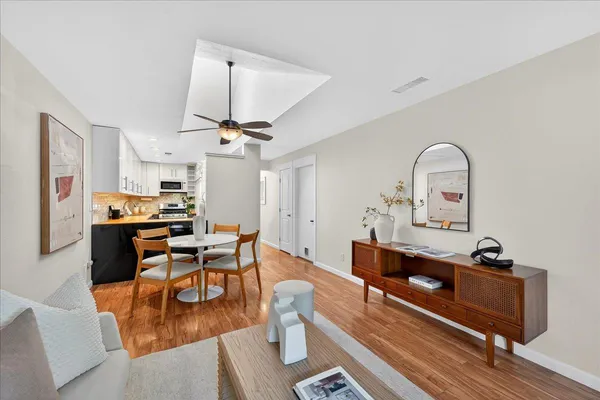 a living room with furniture and kitchen view