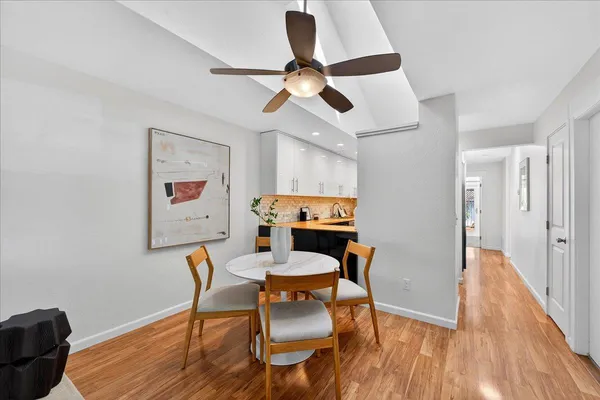 a view of a dining room with furniture and wooden floor