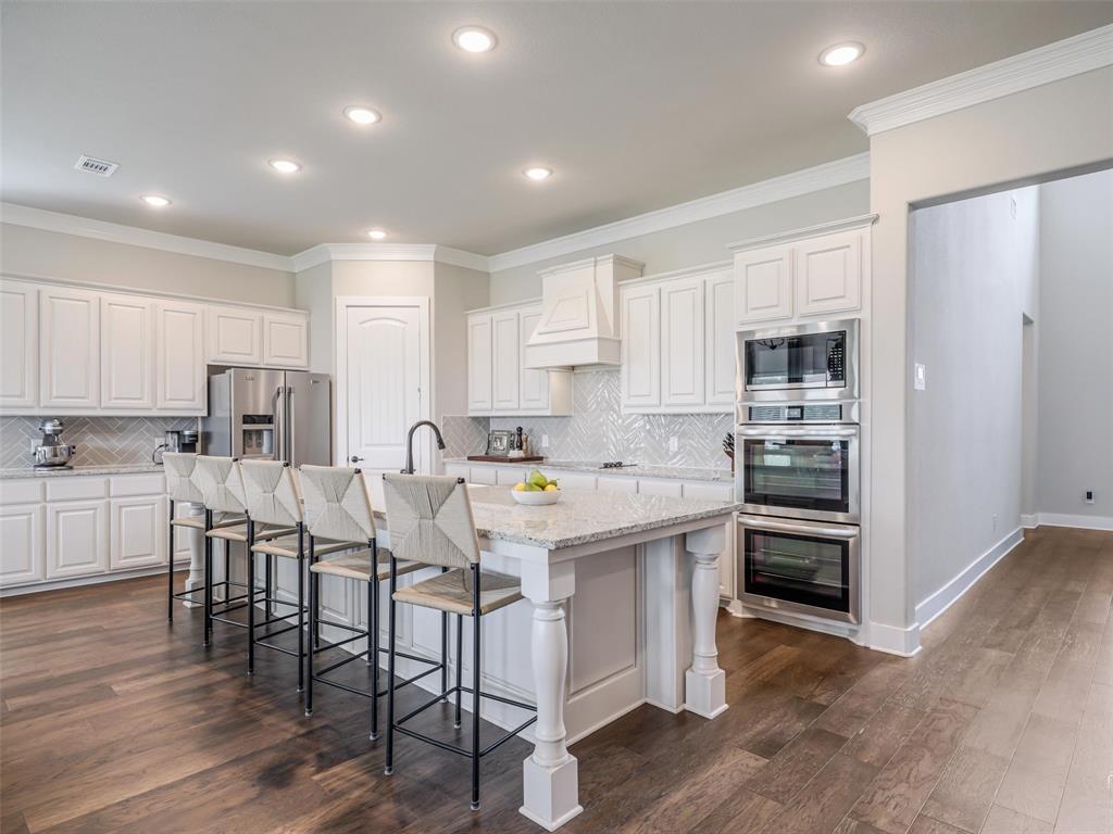 544 Majors Road Van Alstyne, TX 75495 - Photo 3 of 36 a kitchen with white cabinets and stainless steel appliances