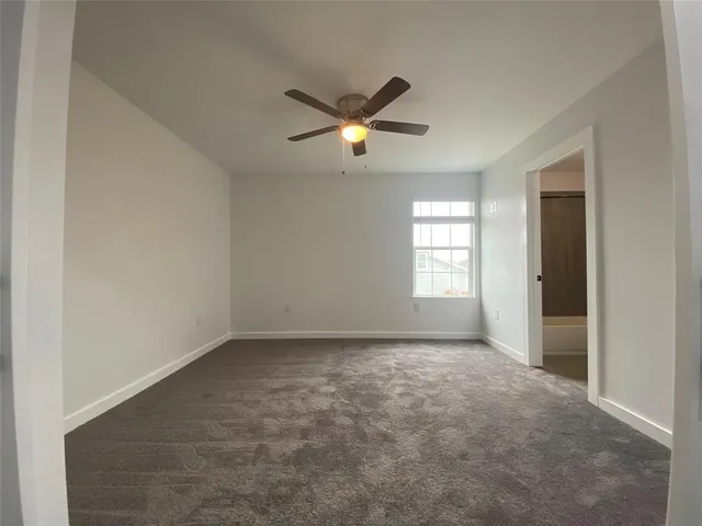 a view of empty room with ceiling fan