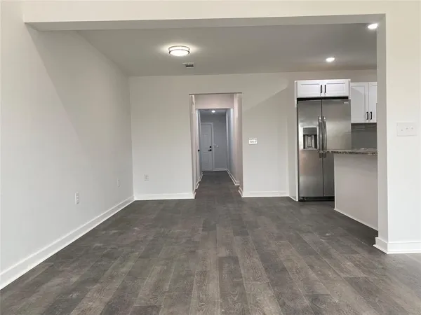 a view of a kitchen with a refrigerator and a sink