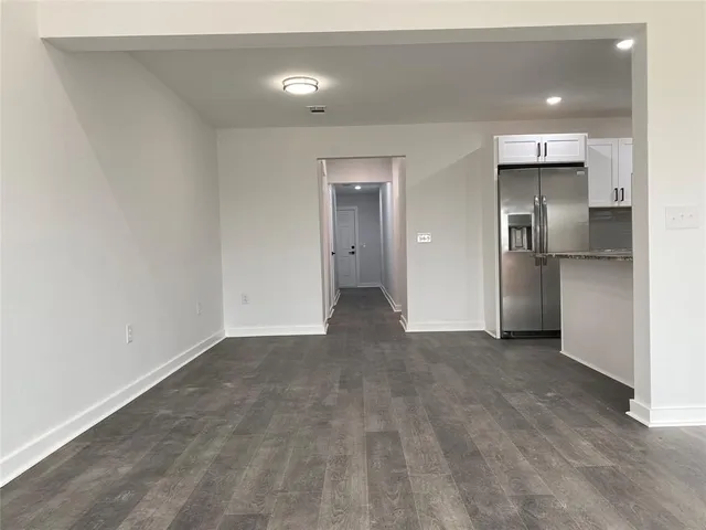 a view of a kitchen with a refrigerator and a sink