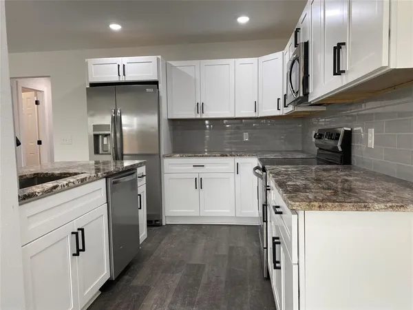 a kitchen with a sink stove and refrigerator