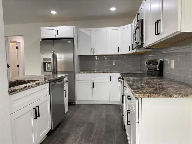a kitchen with a sink stove and refrigerator