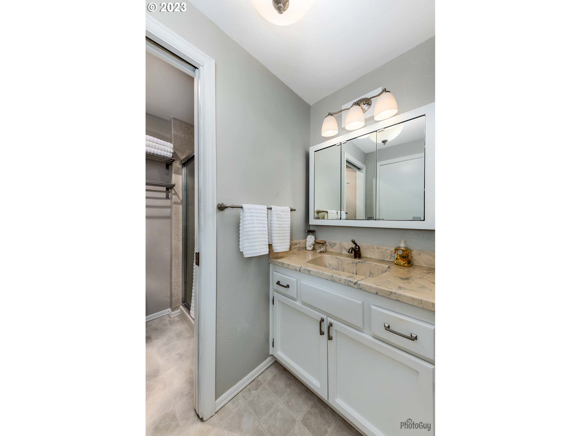 5621 C Street Springfield, OR 97478 - Photo 22 of 29 a en suite bathroom with a sink and a mirror