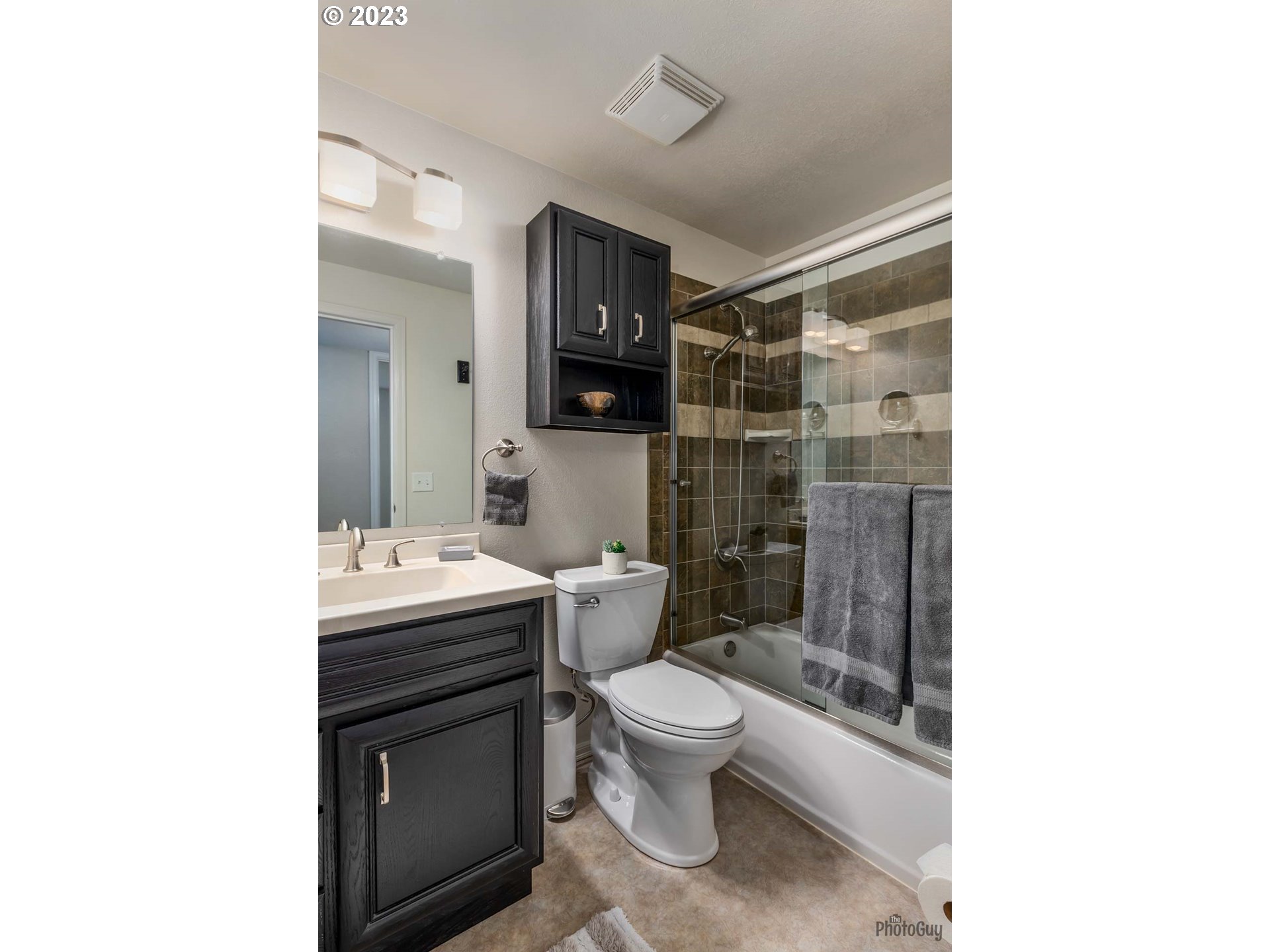 5621 C Street Springfield, OR 97478 - Photo 23 of 29 a bathroom with a toilet a sink and shower