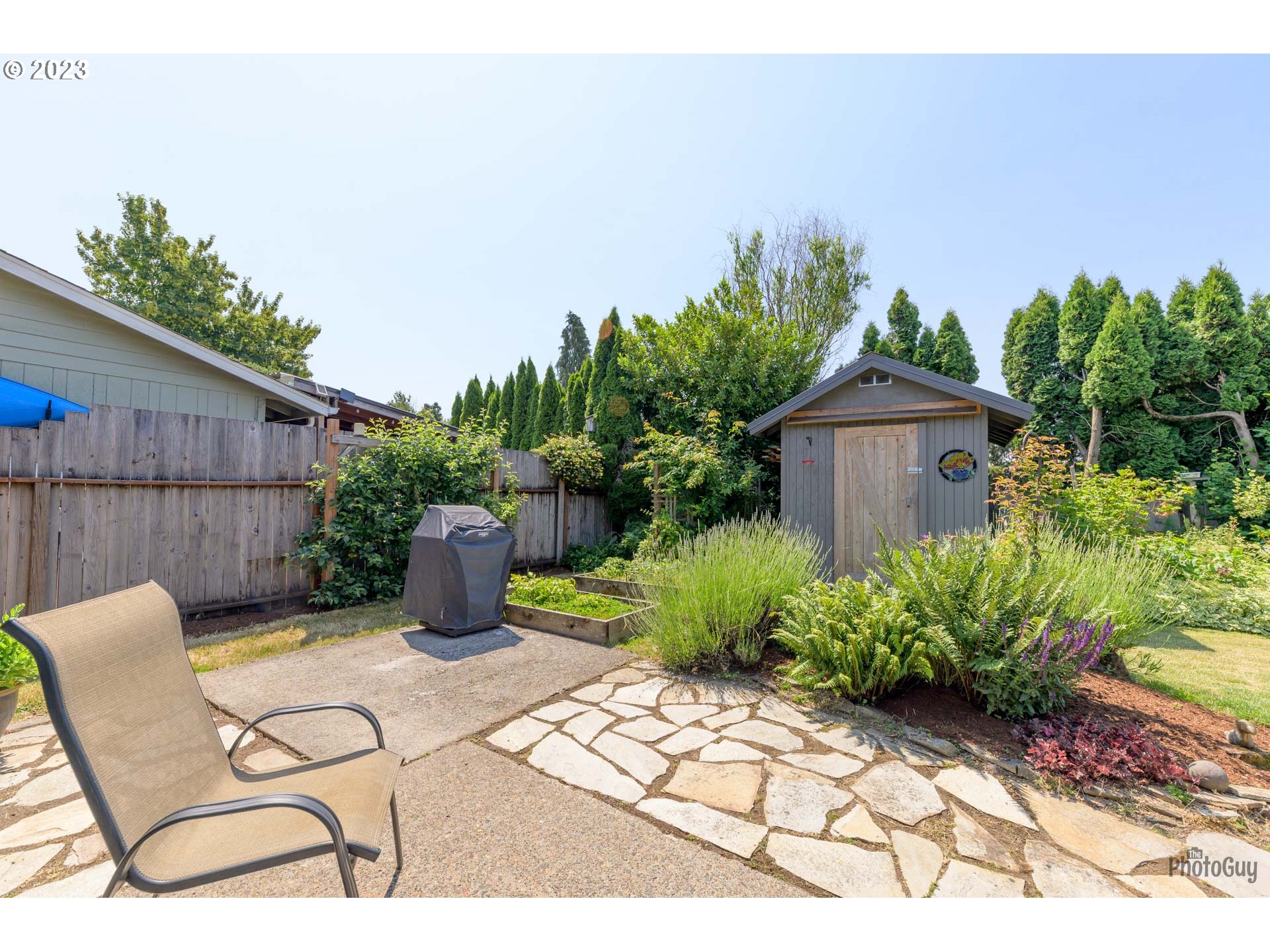 5621 C Street Springfield, OR 97478 - Photo 24 of 29 a view of a backyard with plants and outdoor seating