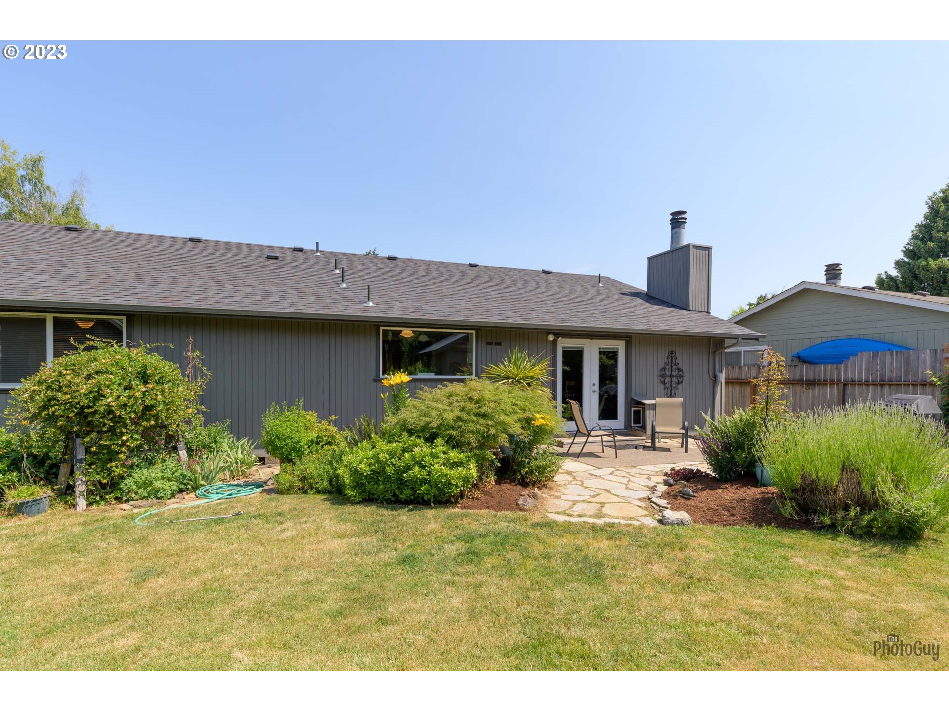 5621 C Street Springfield, OR 97478 - Photo 27 of 29 a front view of a house with a yard and potted plants