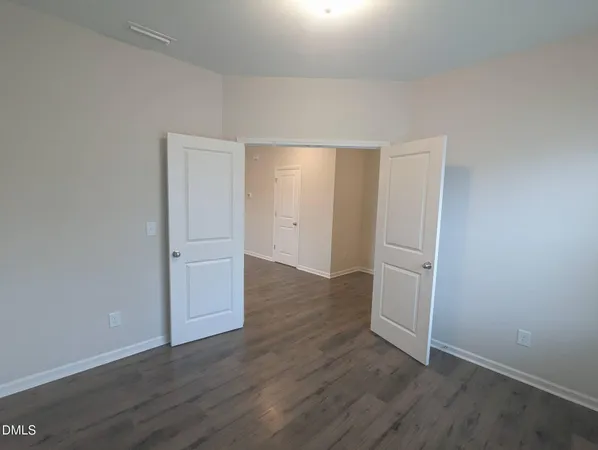 an empty room with wooden floor