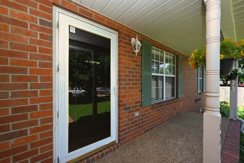 a view of a brick house with a large window
